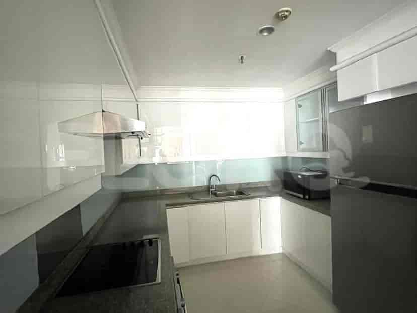 A modern kitchen with white cabinets, a countertop, and kitchen appliances.