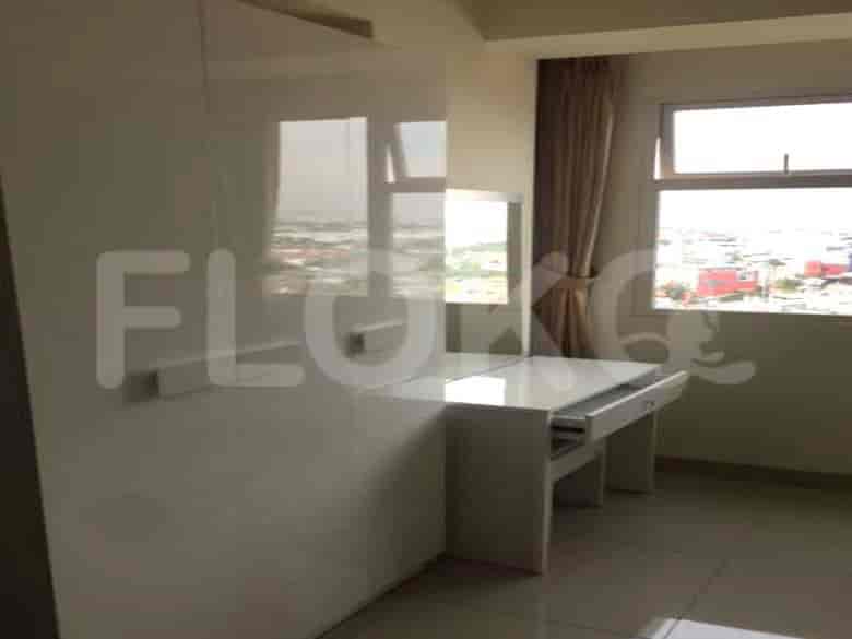 Bedroom with a large wardrobe, and vanity with a mirror, offering ample storage and getting-ready space.