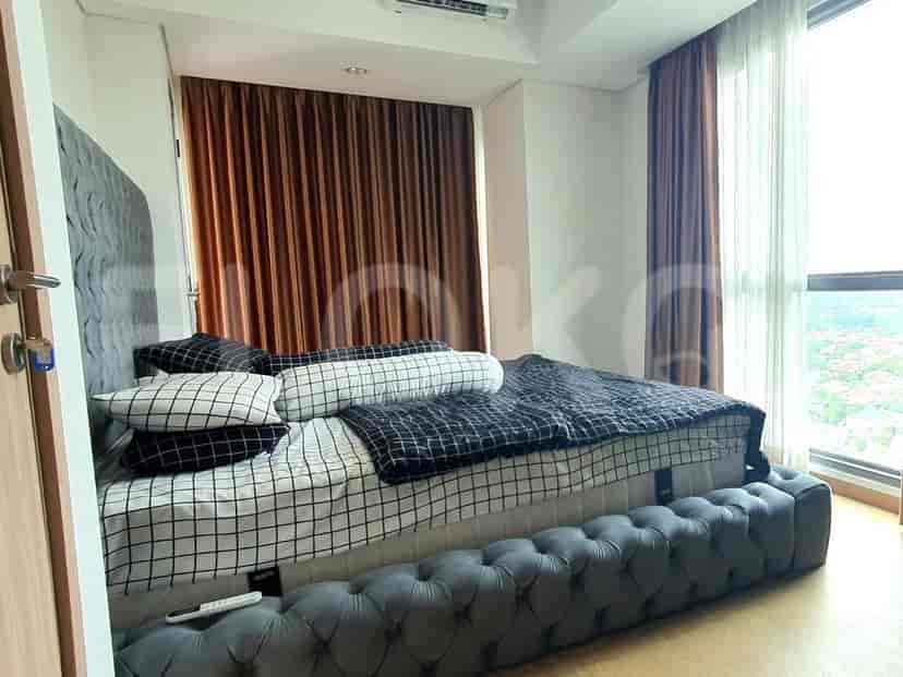 Modern bedroom with a bed, night curtains and city view.