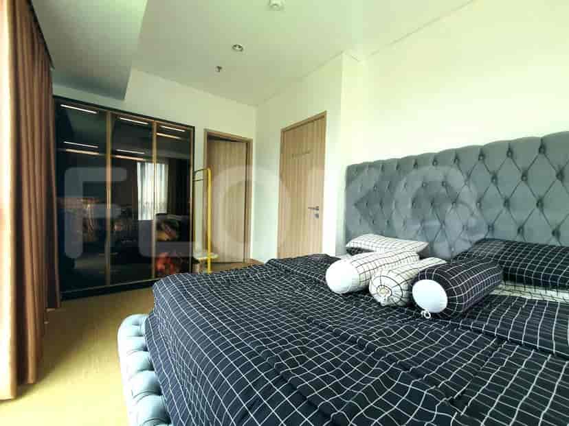 Master bedroom with large bed, wardrobe, and city view.