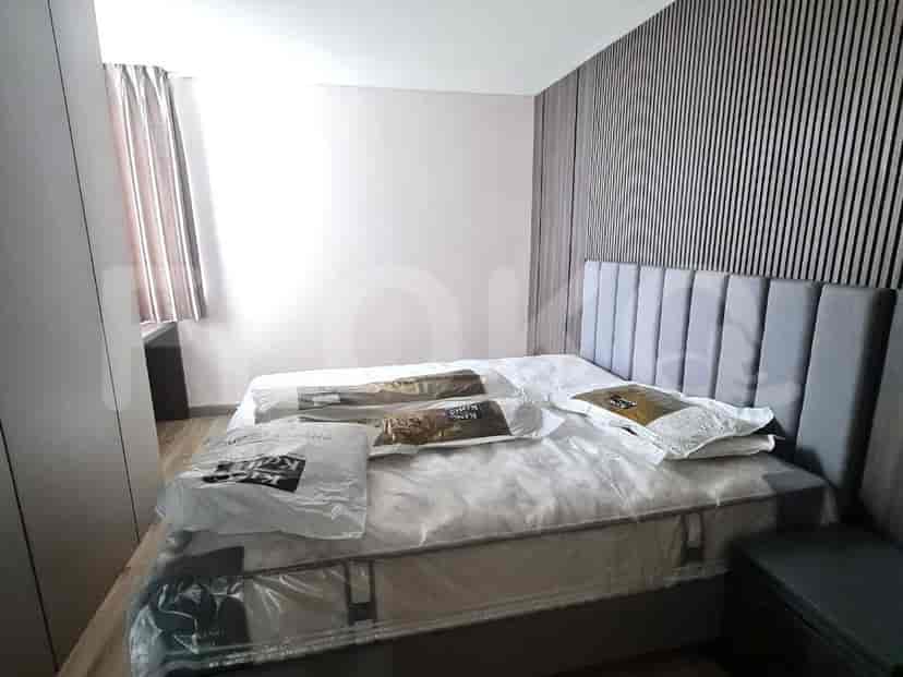 Kamar tidur modern dengan tempat tidur besar, dinding kayu, dan lemari.