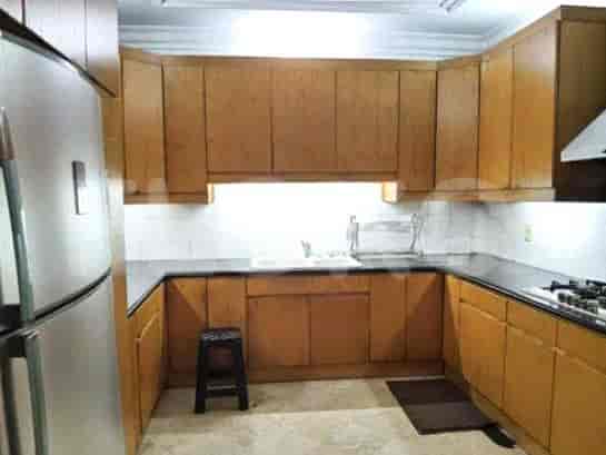 Kitchen with wooden cabinets, appliances, and a sink.