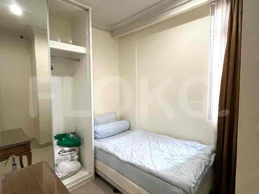 Bedroom with a bed, wardrobe, and window.