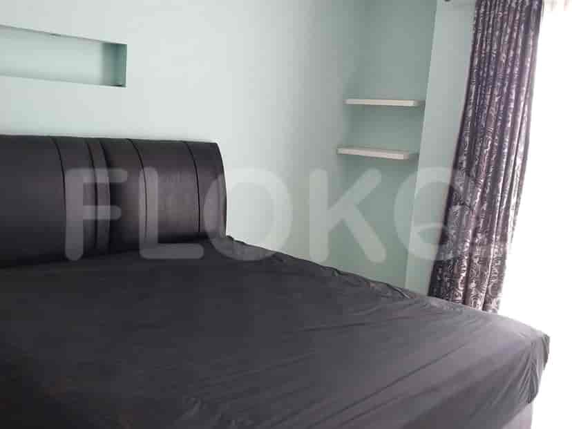 Master bedroom with a black bed and floating shelves.
