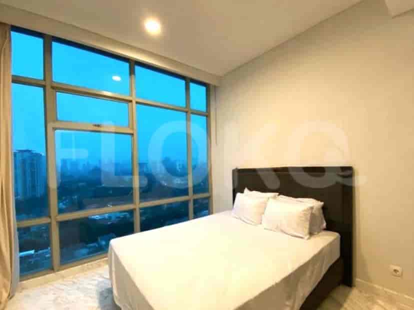 A bedroom featuring a large window with a city view and a comfortable bed.