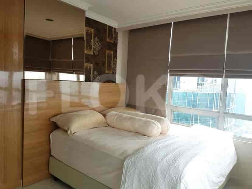 Bedroom with bed, wooden headboard, and wardrobe.