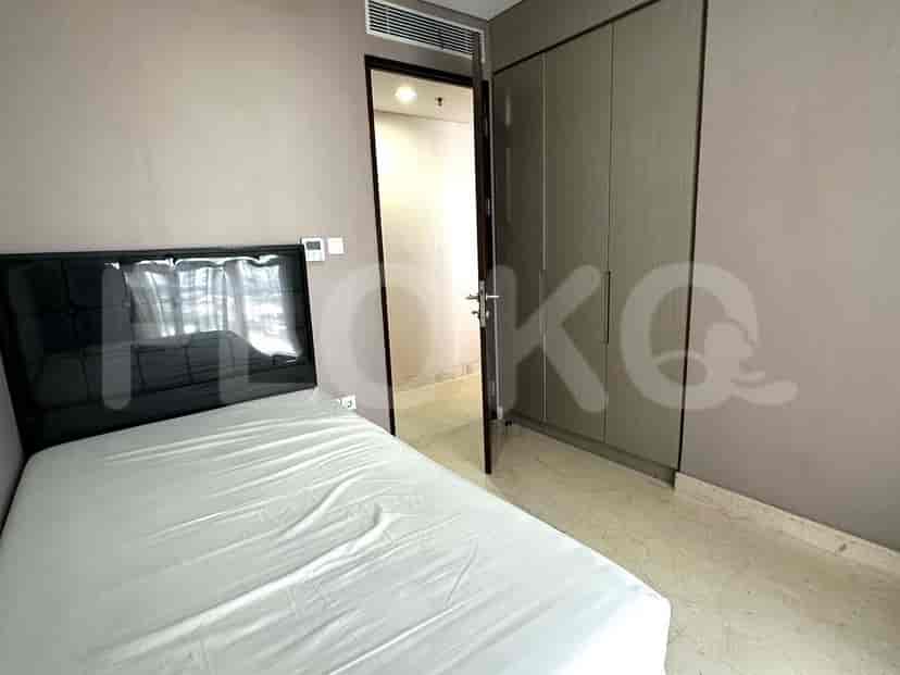 A well-lit bedroom with a king-size bed, dresser, and large window.
