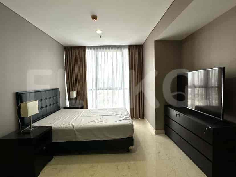 A bedroom with a single bed and large window offering city views.