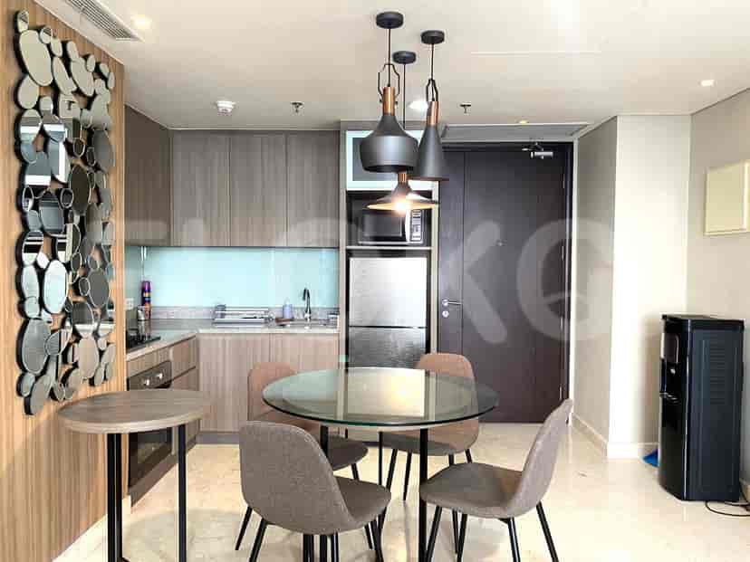 Modern kitchen and dining area with built-in appliances and a round dining table.