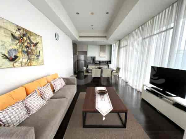 An open-concept living and dining area with a modern aesthetic. Features include a dining table, kitchen, and floor-to-ceiling windows.