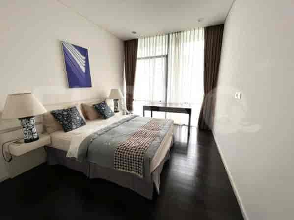 Another view of a modern bedroom with a king-sized bed and a large window.