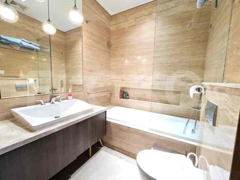Modern bathroom with a bathtub and sink.