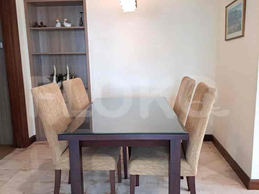 Dining area with a glass-top table and chairs.