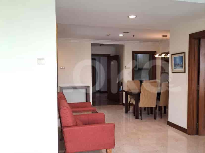 Living room with red armchairs and dining area.