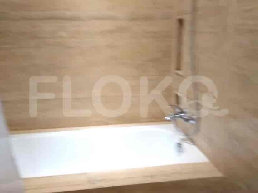 A bathroom featuring a bathtub and tiled walls.