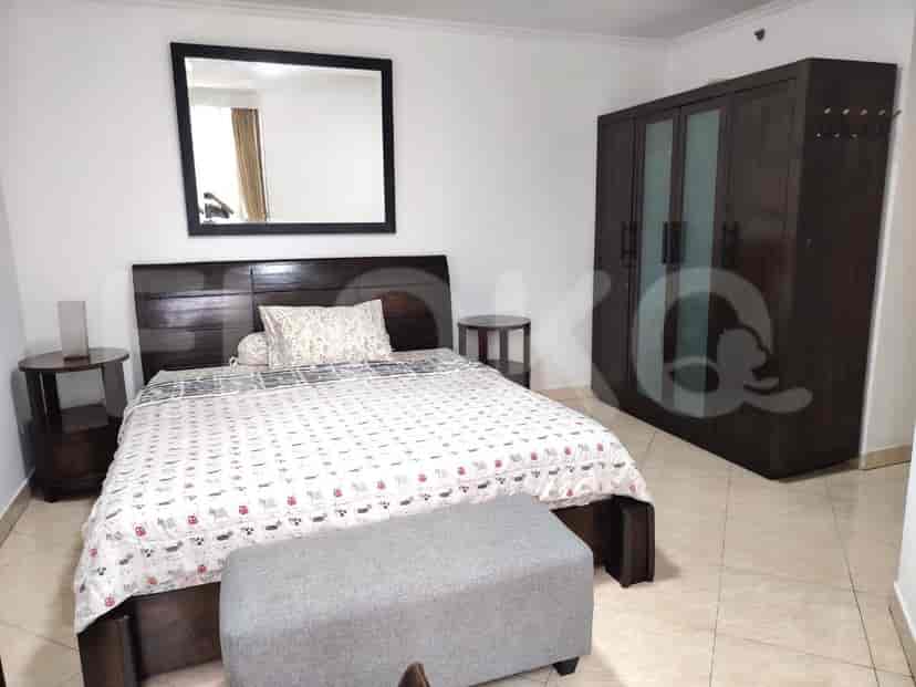 Bedroom with a double bed, wardrobe, and side tables.