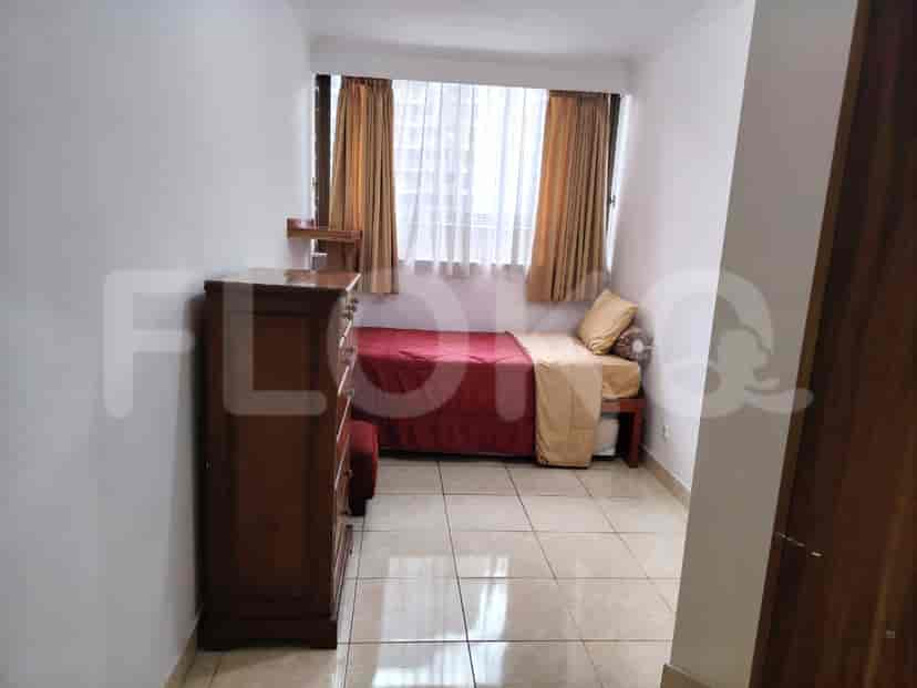 Small bedroom with a single bed and dresser.