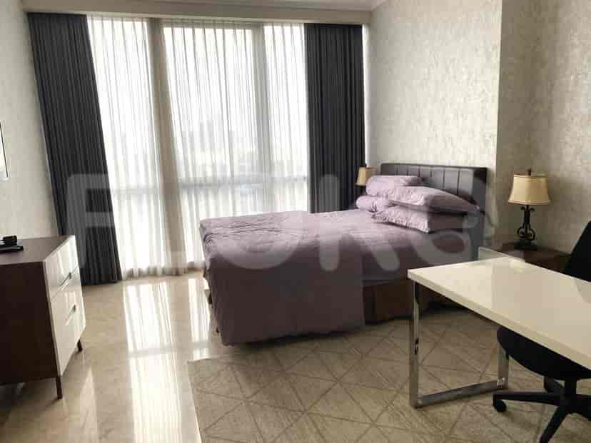 A bedroom featuring a large bed, full-length curtains and a minimalist design.