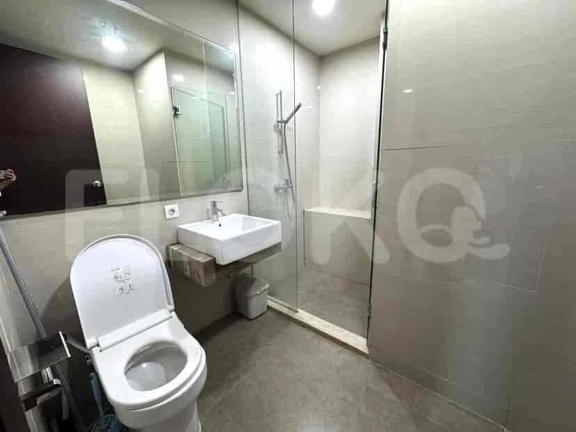 Modern bathroom with sink, toilet, and shower.