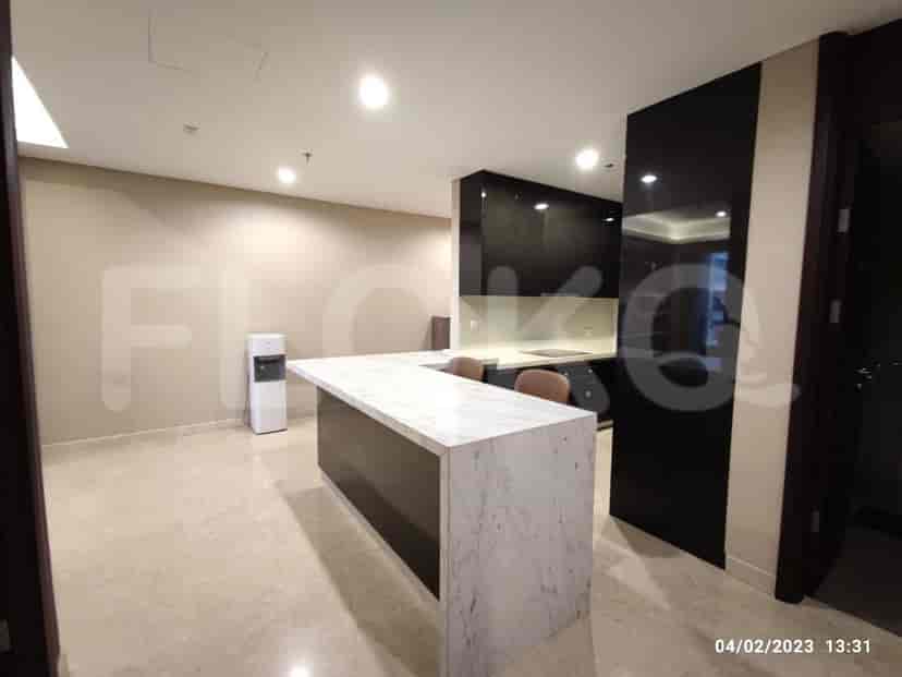 A modern kitchen with a central island and sleek cabinetry.