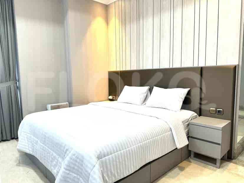 Bedroom with a large bed and a minimalist design.