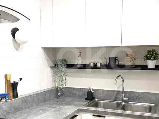 A modern kitchen with white cabinets and a gray countertop.