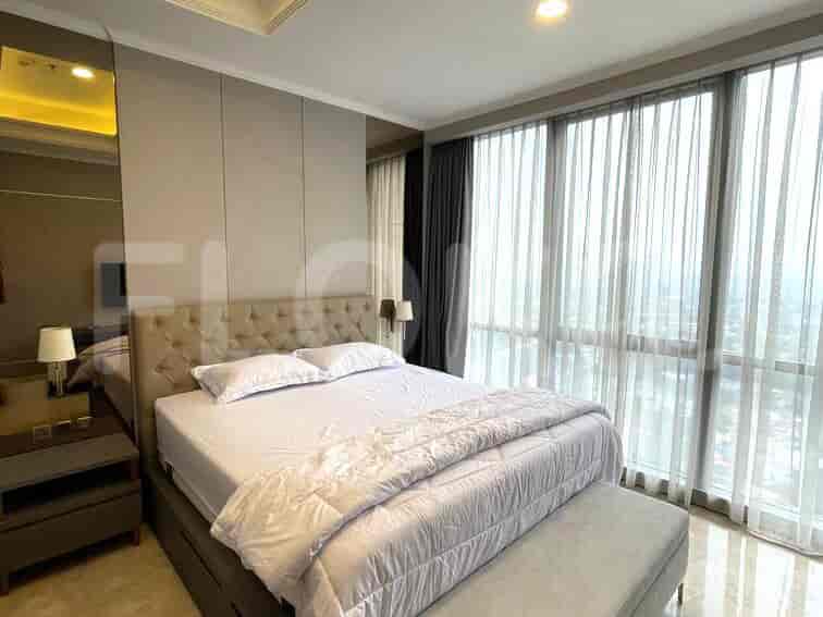 A spacious bedroom with a large bed and floor-to-ceiling windows.