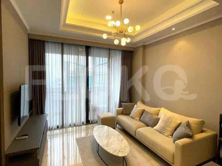 A modern living room with a sofa, marble coffee table, and large windows.