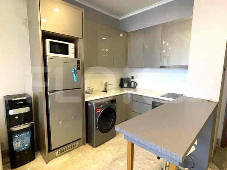 A modern kitchen with stainless steel appliances and an electric stove.