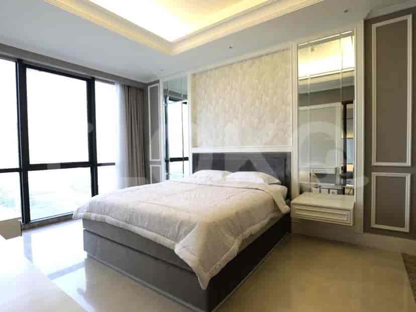 A modern bedroom with large windows, mirrors, and a bed.