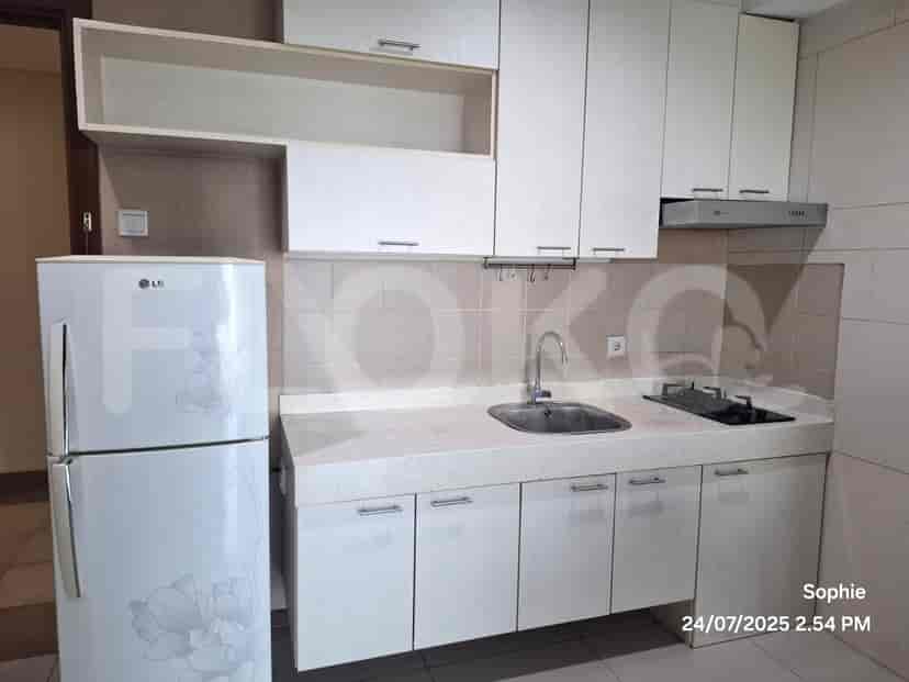 A kitchen with cabinets, a refrigerator, and a stove.