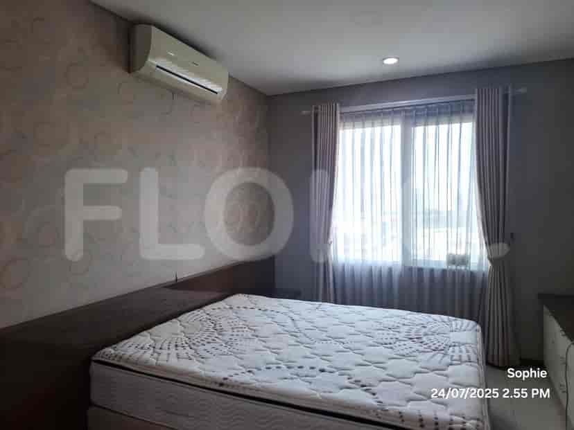 A bedroom with a bed, air conditioner, and a patterned wallpaper.
