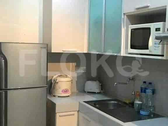 A kitchen featuring a refrigerator, microwave, and sink.