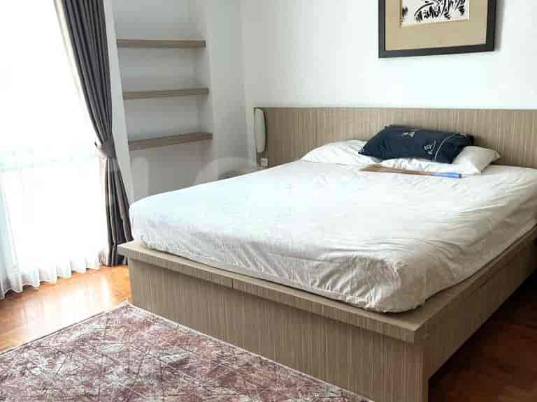 Bedroom with a bed and wooden accents.