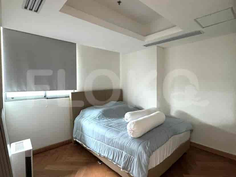 A cozy bedroom with a bed, a window, and a simple design.