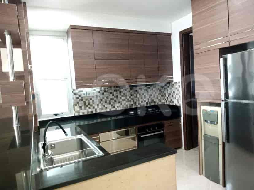Kitchen with wooden cabinets, a black countertop, and stainless steel appliances.