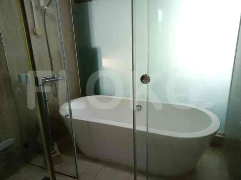 Bathroom with a bathtub and glass shower enclosure.