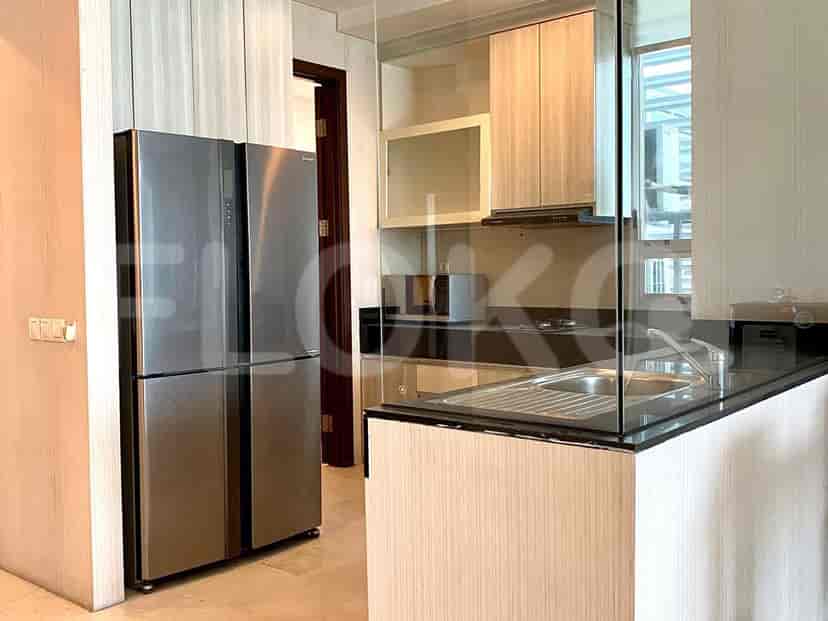 Modern kitchen featuring stainless steel appliances and light wood cabinetry.