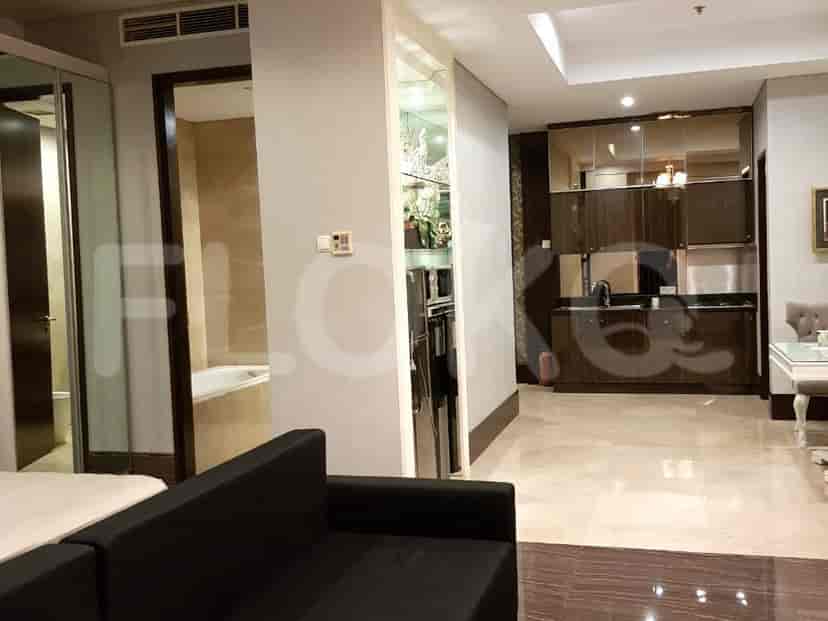 Modern kitchen and bathroom with a glimpse of the living room.