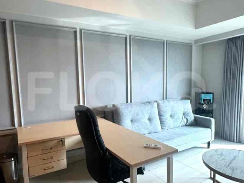 Living space with a work desk, sofa, and a small coffee table.