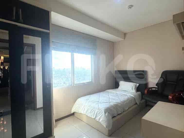 Single bed in a guest bedroom with window view.