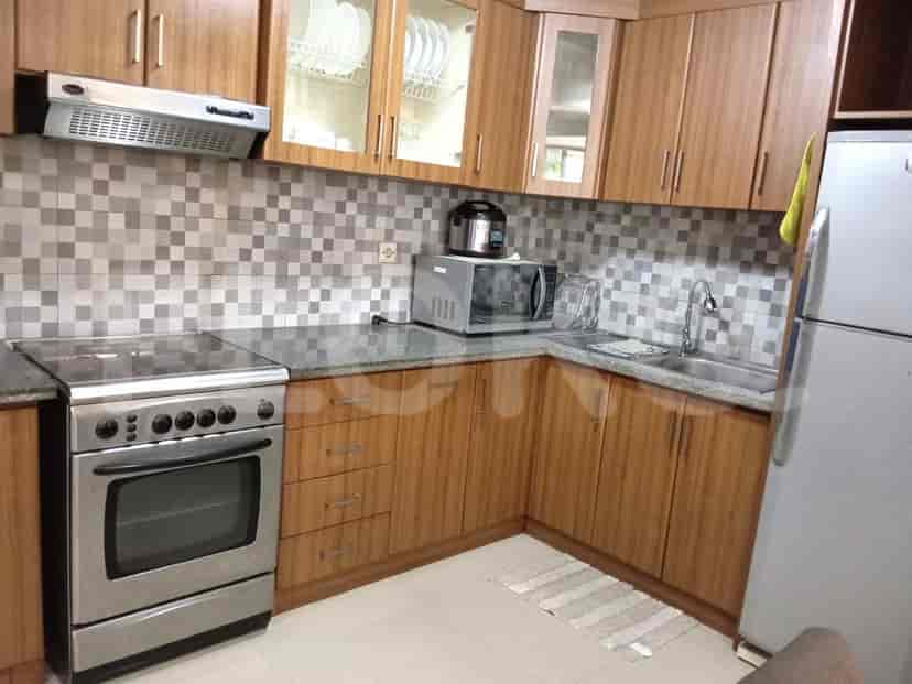Kitchen with cabinets, stove, and refrigerator.