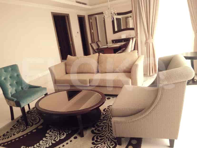 A living room with a sofa, chairs, and a round coffee table.