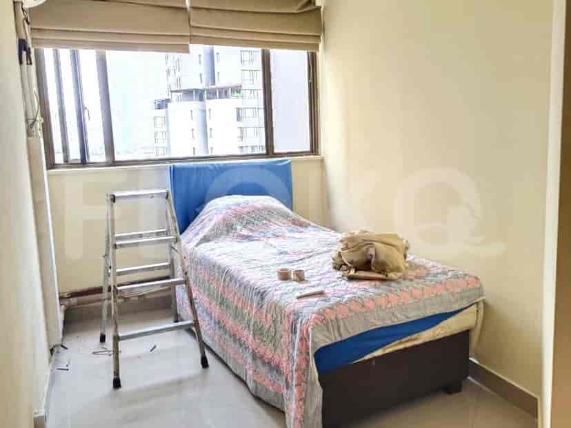 A bedroom with a bed, a window, and a ladder.