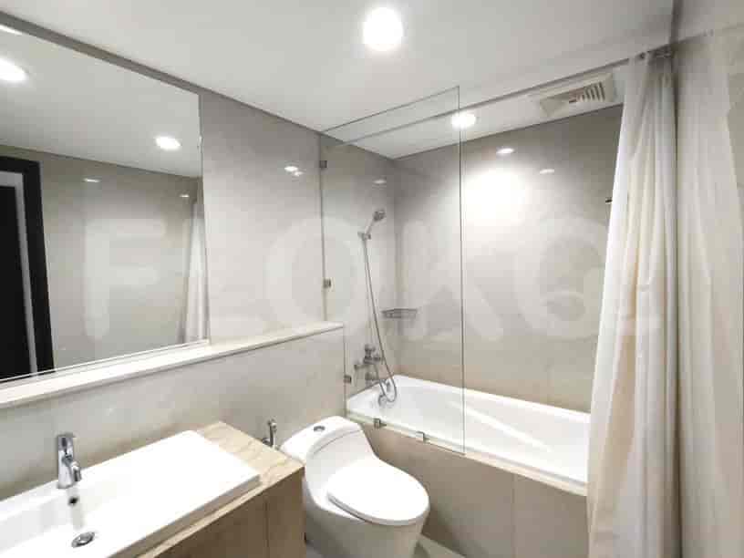 A modern bathroom with a bathtub, shower, and vanity.