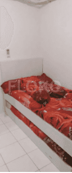 Bedroom with a single bed and red bedding.