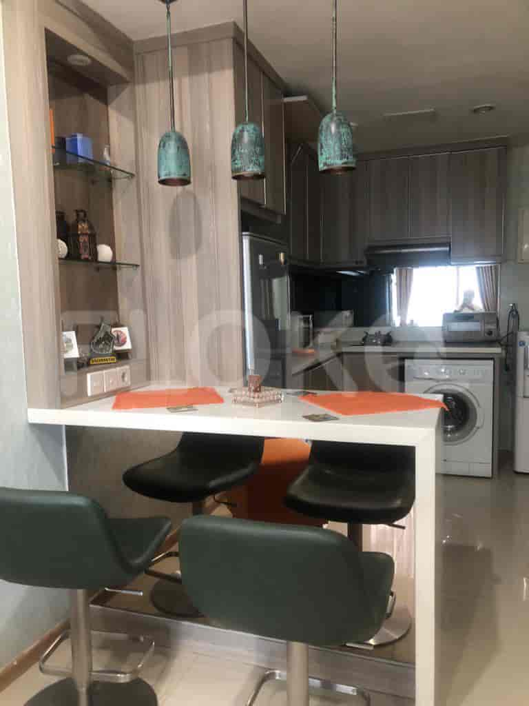 Modern kitchen with breakfast bar, pendant lights, and stainless steel appliances.