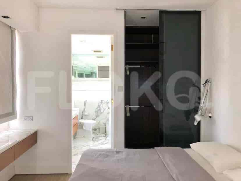 A bedroom showing a bed, a sliding closet, and an en-suite bathroom.