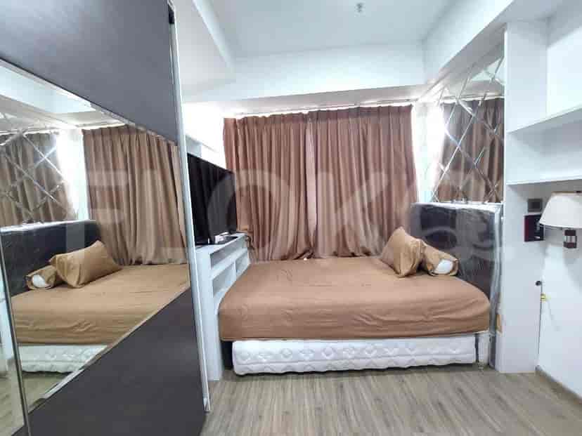 Bedroom with double bed, mirror and television.