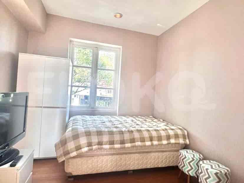 A bedroom featuring a double bed, a window, and minimalist decor.